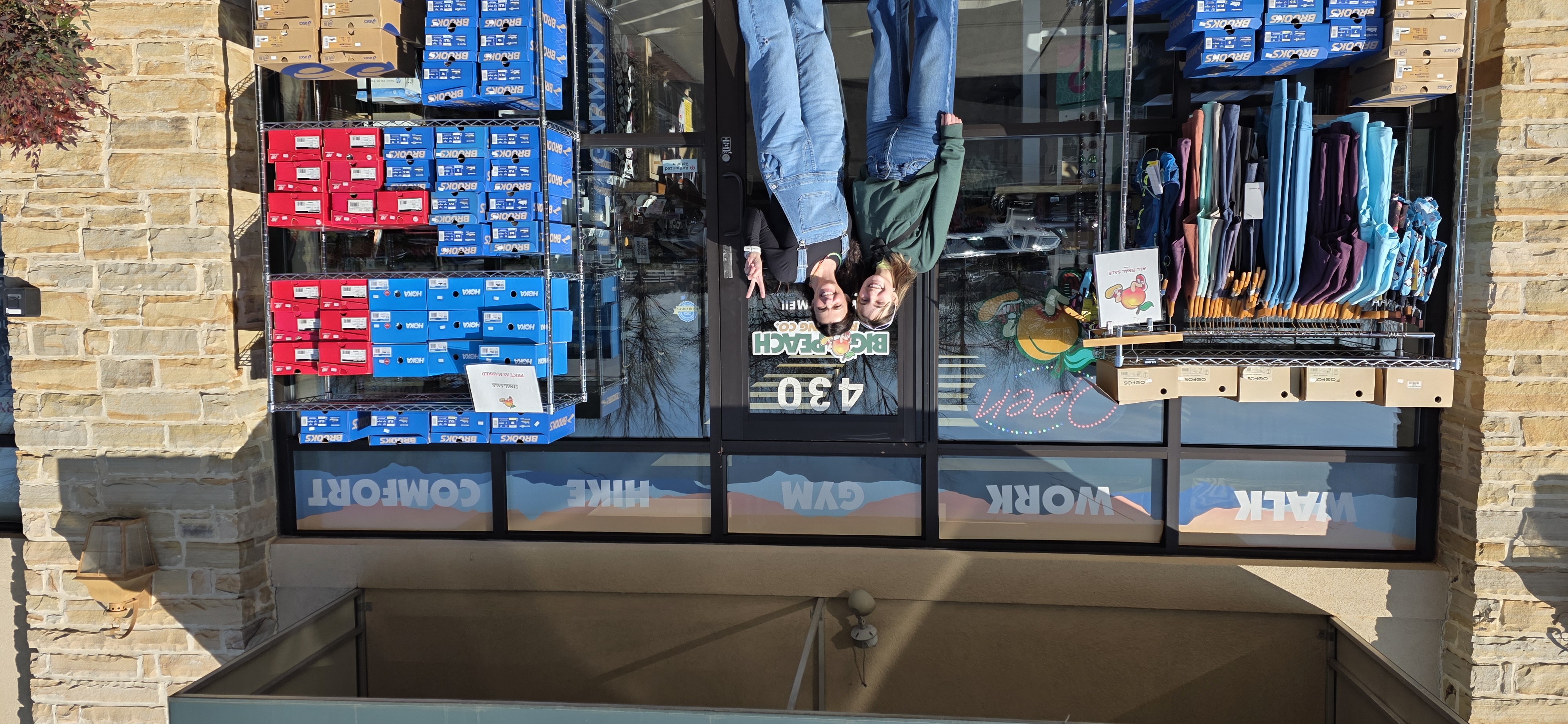 Two women in front of the Big Peach Running Company storefront