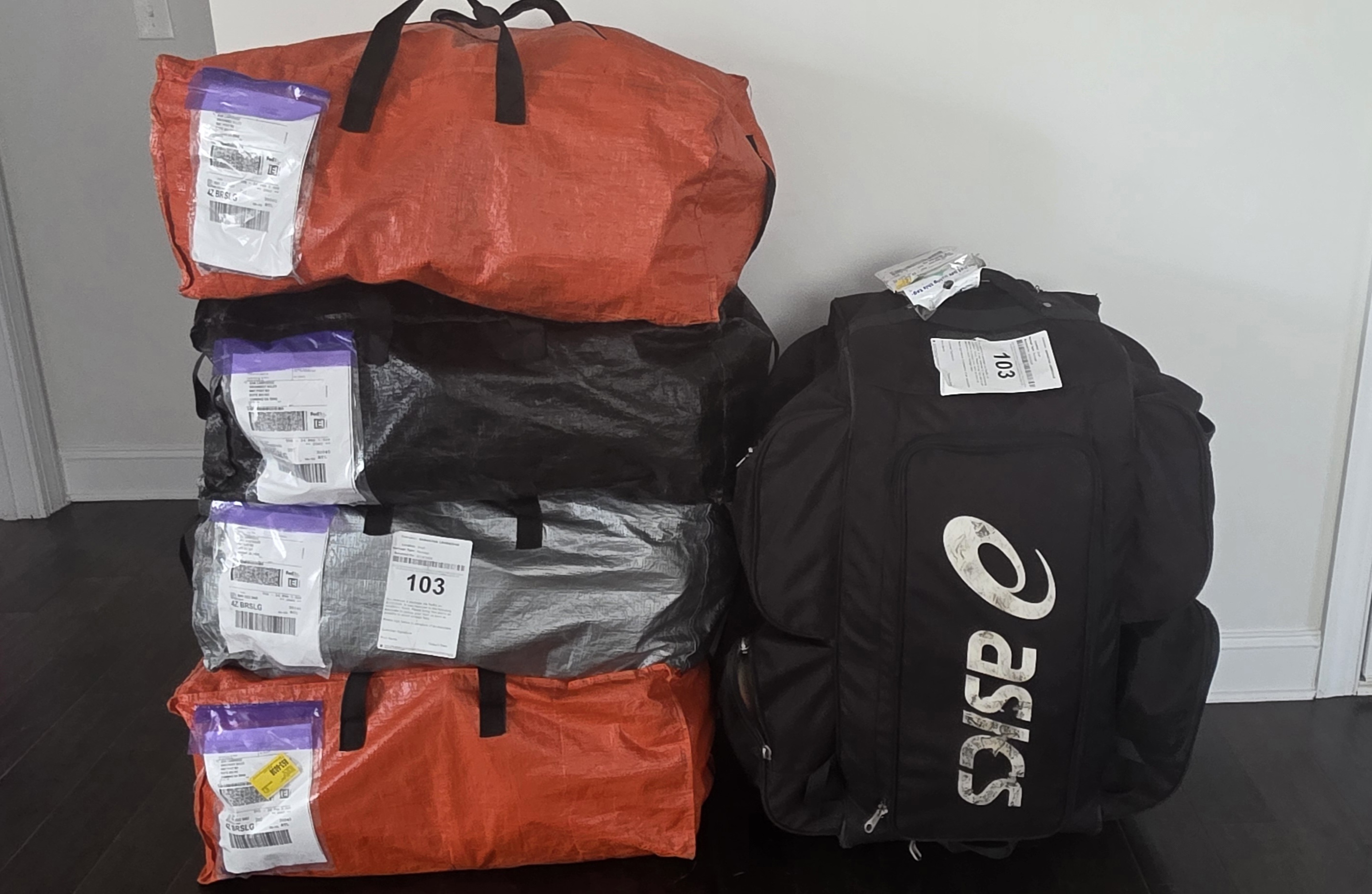Bags of donated shoes from the ASICS in-kind donation, ready for sorting
