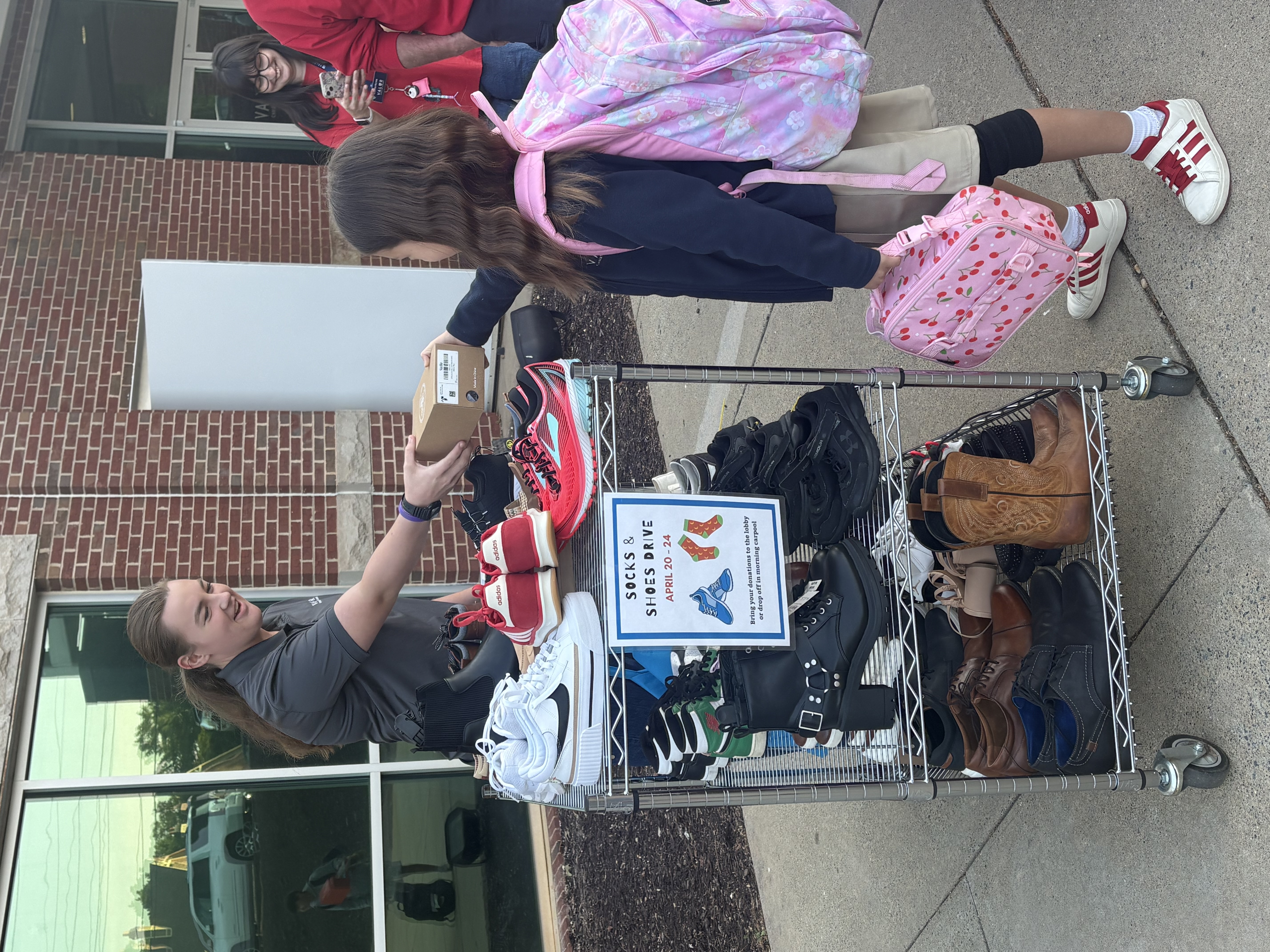 Student donating a shoe box at the Valor Christian Academy shoe drive